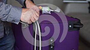Hand Unzipping A Trolley Suitcase