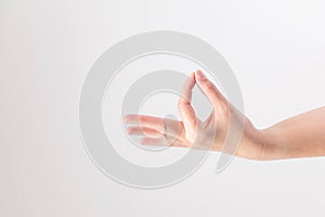 Hand supine and touching tip of thumb and forefinger together on white background; posturing like holding very small, thin and photo