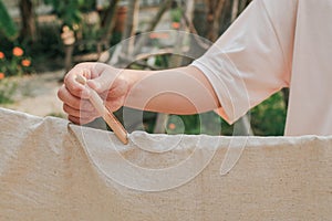 Ã Â¹â¡Hand use clothes pegs hanging fresh clean white towels on drying rack outdoor.Washing day housework with laundry.