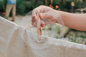 Ã Â¹â¡Hand use clothes pegs hanging fresh clean white towels on drying rack outdoor.Washing day housework with laundry.