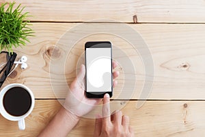 Hand use phone on wood table photo