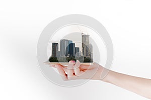 The hand uses a smartphone or tablet, looking for real estate or future investment. Investment concept