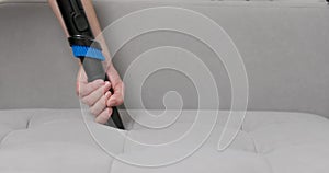Hand Using Brush Attachment on Vacuum Cleaner