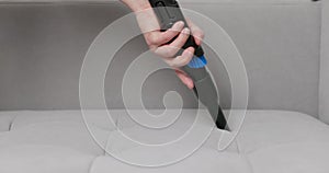 Hand Using Brush Attachment on Vacuum Cleaner