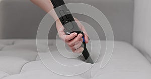 Hand Using Brush Attachment on Vacuum Cleaner