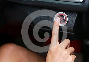 Hand using Car engine start-stop button