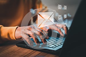 Hand using computer laptop and sending online message with email icon, email marketing concept.