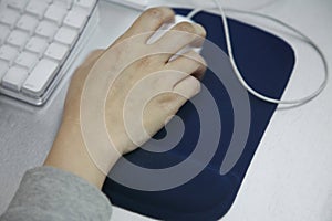 Hand using computer mouse