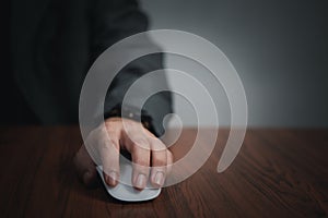 Hand using computer mouse, clicking pointer laptop on desk