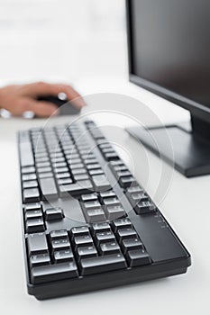 Hand using computer mouse at desk