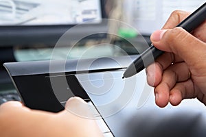 Hand using digital pen tablet