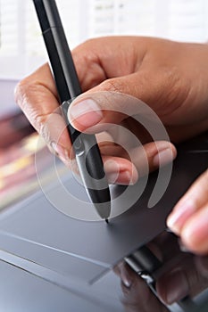 Hand using digital pen tablet