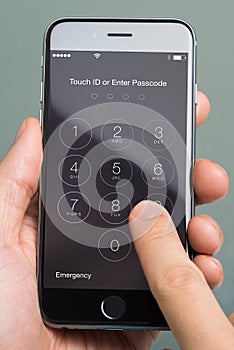 Hand Using Enter Passcode Application On Apple iPhone6