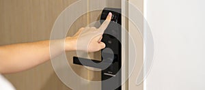 Hand using fingerprint scan for smart digital door lock while open or close the door at home or apartment. NFC Technology, keycard