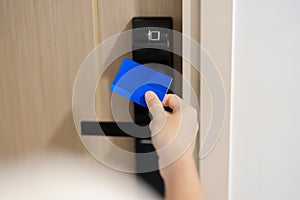 Hand using keycard for smart digital door lock while open or close the door at home or apartment. NFC Technology, Fingerprint scan