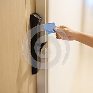 Hand using keycard for smart digital door lock while open or close the door at home or apartment. NFC Technology, Fingerprint scan