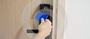 Hand using keycard for smart digital door lock while open or close the door at home or apartment. NFC Technology, Fingerprint scan