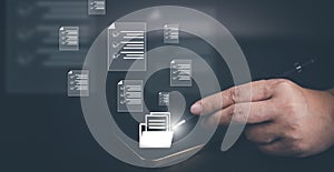 Hand using laptop and touch folder of document Management System, online documentation database and process automation to efficien