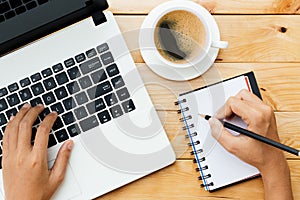 Hand using laptop and write note inspire idea on wood