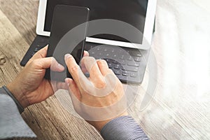 Hand using mobile payments online shopping,omni channel,icon customer network,in modern office wooden desk, graphic interface