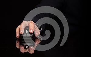 Hand using mouse on dark background