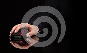 Hand using mouse on dark background