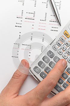 Hand using scientific calculator for business