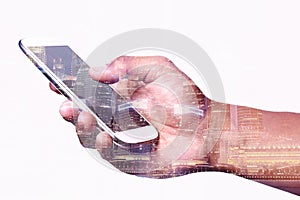 Hand using smartphone with cityscape background