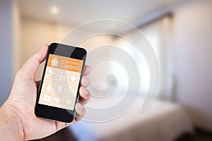 Hand using smartphone to smart home app on mobile.