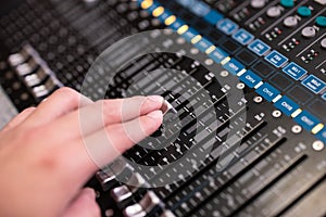 Hand using sound music mixer control panel