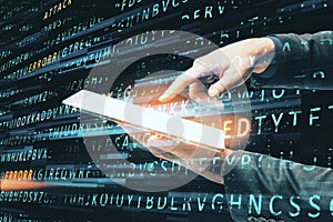 Hand using tablet on creative hacking background