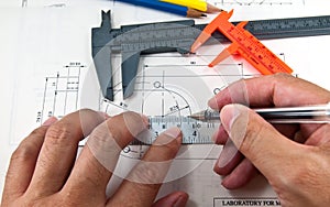 Hand using tools create a technical drawings