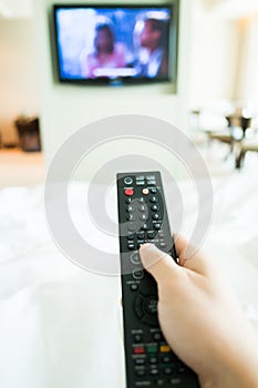 Hand using tv remote control