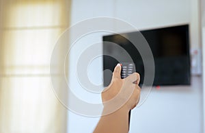 Hand using with TV remote control on-off mode