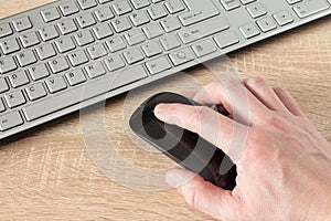 Hand using wireless computer mouse