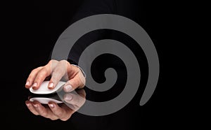 Hand using mouse on dark background