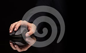 Hand using mouse on dark background