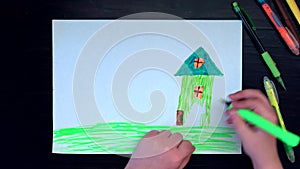 Only hand. The view from the top. The child draws on white paper. Color dreams. Modern style. Speed up video