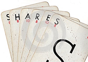 A hand of vintage playing cards spelling the word SHARES.