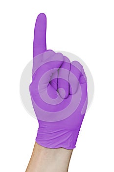 Hand in violet medical glove showing attention sign with forefinger up, isolated on white background