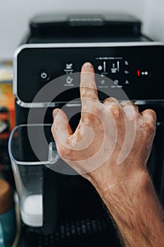 A Hand with Vitiligo Using The Coffee Machine