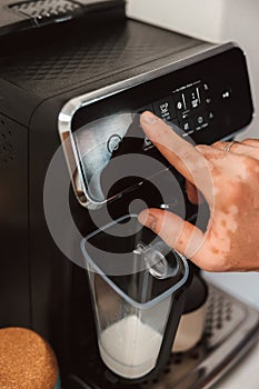 A Hand with Vitiligo Using The Coffee Machine