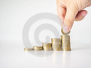 The hand was picking up the money that had been stacked up in layers. White background