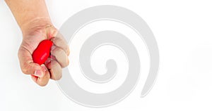 The hand was squeezing the red heart until it flattened. Depict an angry mood On a white background