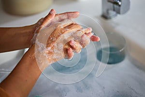 Hand wash, cleaning and sink washing for healthcare, wellness and virus safety in a bathroom. Skin health, bacteria