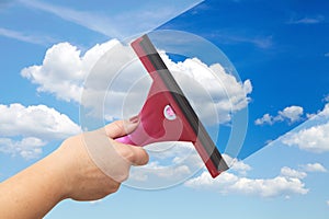 A hand washes the blue sky