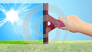 A hand washes the blue sky