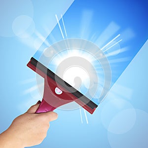 A hand washes the blue sky