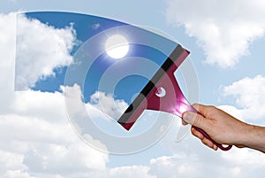 A hand washes the blue sky