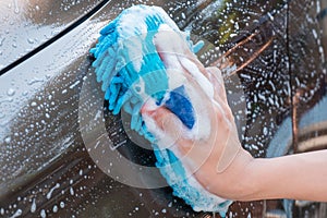 Hand washing Brown Car with blue sponge and bubbles Foam